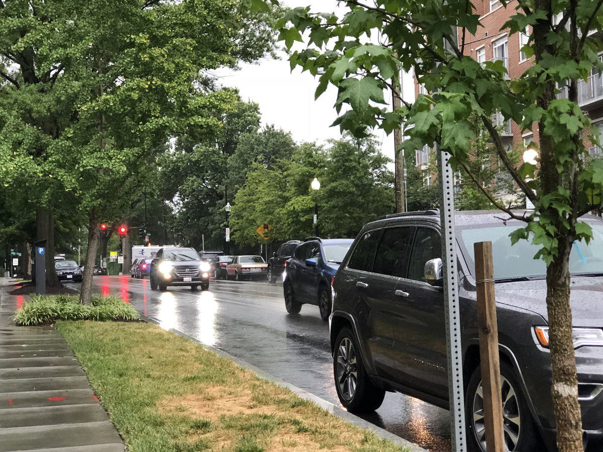 Cars drive down Idaho Avenue NW in the rain in D.C. on Tuesday, July 24. The weather has caused a lot of problems on local roads. (WTOP/Patrick Roth)