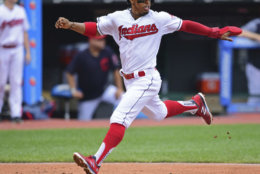 Cleveland Indians' Francisco Lindor scores on a one-run double by Edwin Encarnacion in the first inning of a baseball game against the Detroit Tigers, Sunday, June 24, 2018, in Cleveland. (AP Photo/David Dermer)