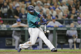 Seattle Mariners' Jean Segura hits and RBI single against the Kansas City Royals during a baseball game, Friday, June 29, 2018, in Seattle. (AP Photo/John Froschauer)
