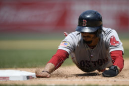 Boston Red Sox' Mookie Betts dives back to first safely on a pick-off attempt during the sixth inning of a baseball game against the Washington Nationals, Wednesday, July 4, 2018, in Washington. The Red Sox beat the Nationals 3-0. (AP Photo/Nick Wass)
