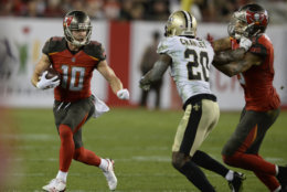 Tampa Bay Buccaneers wide receiver Adam Humphries (10) runs with a reception in front of New Orleans Saints cornerback Ken Crawley (20) during the second half of an NFL football game Sunday, Dec. 31, 2017, in Tampa, Fla. (AP Photo/Jason Behnken)
