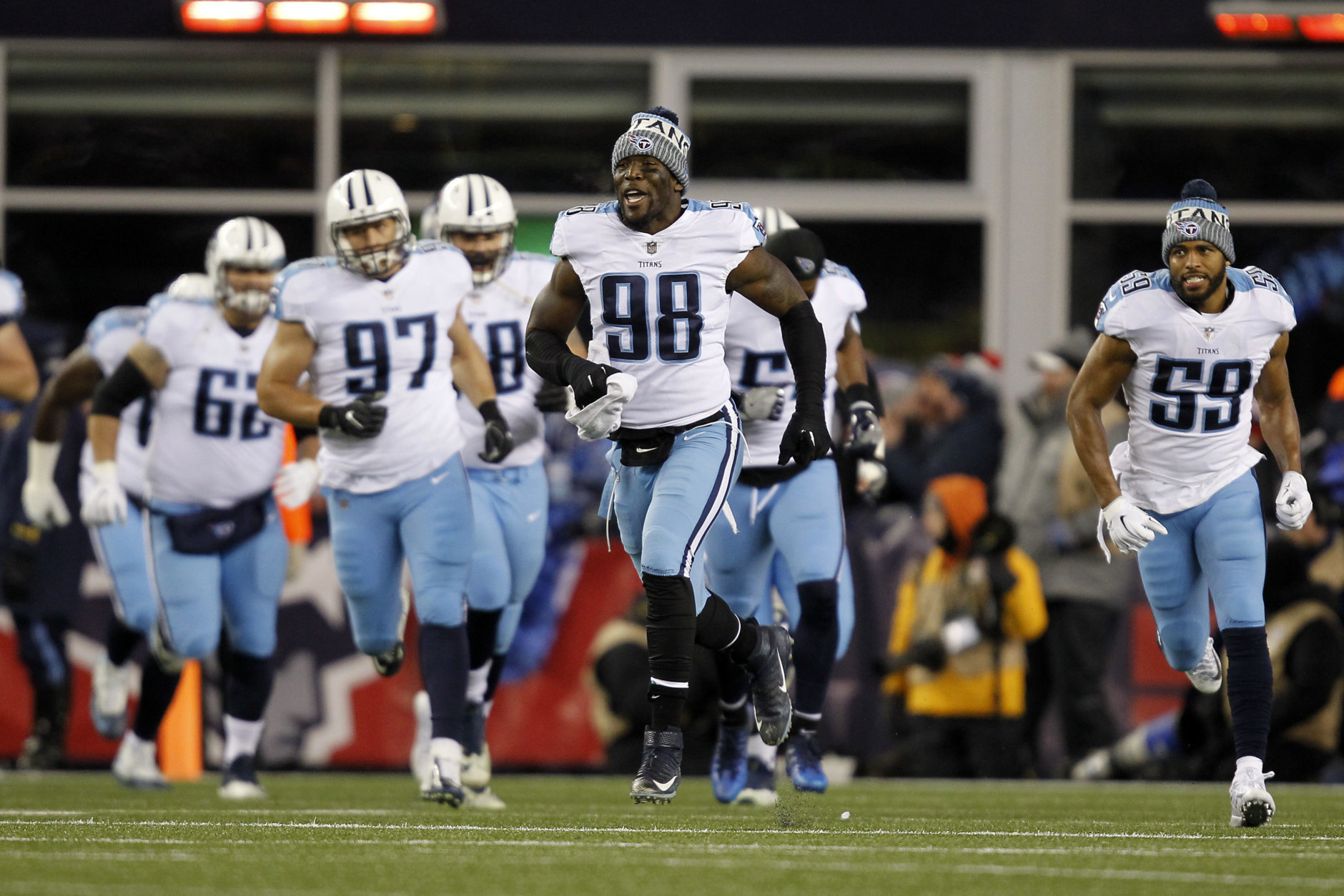 Tennessee Titans linebacker Brian Orakpo (98) along with the rest of the team run onto the field prior to an NFL divisional playoff football game against the New England Patriots, Saturday, Jan. 13, 2018, in Foxborough, Mass. . (AP Photo/Stew Milne)