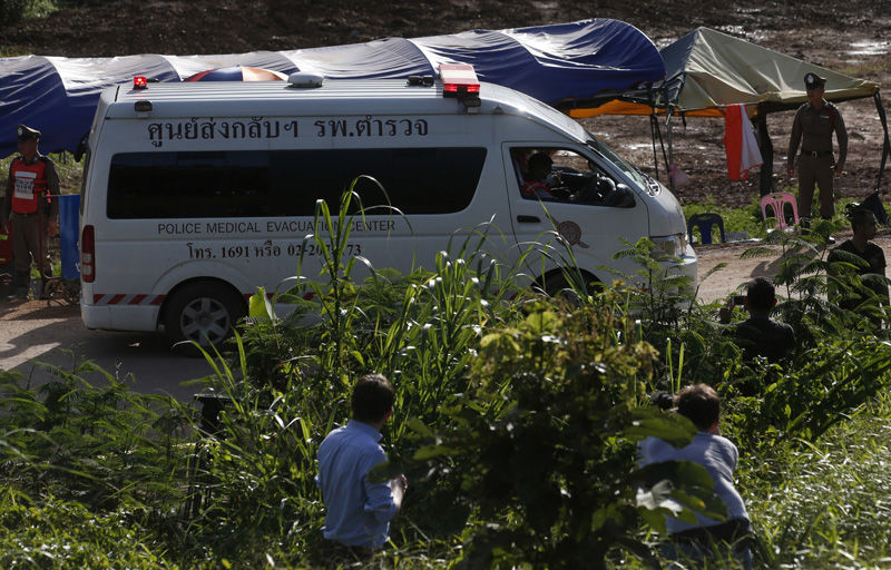 An ambulance with flashing lights leaves the cave rescue area in Mae Sai, Chiang Rai province, northern Thailand, Monday, July 9, 2018. The ambulance has left the cave complex area hours after the start of the second phase of an operation to rescue a youth soccer team trapped inside the cave for more than two weeks. (AP Photo/Sakchai Lalit)