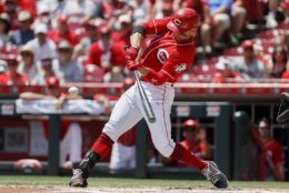 Cincinnati Reds' Joey Votto hits an RBI double off Milwaukee Brewers starting pitcher Freddy Peralta in the first inning of a baseball game, Sunday, July 1, 2018, in Cincinnati. (AP Photo/John Minchillo)