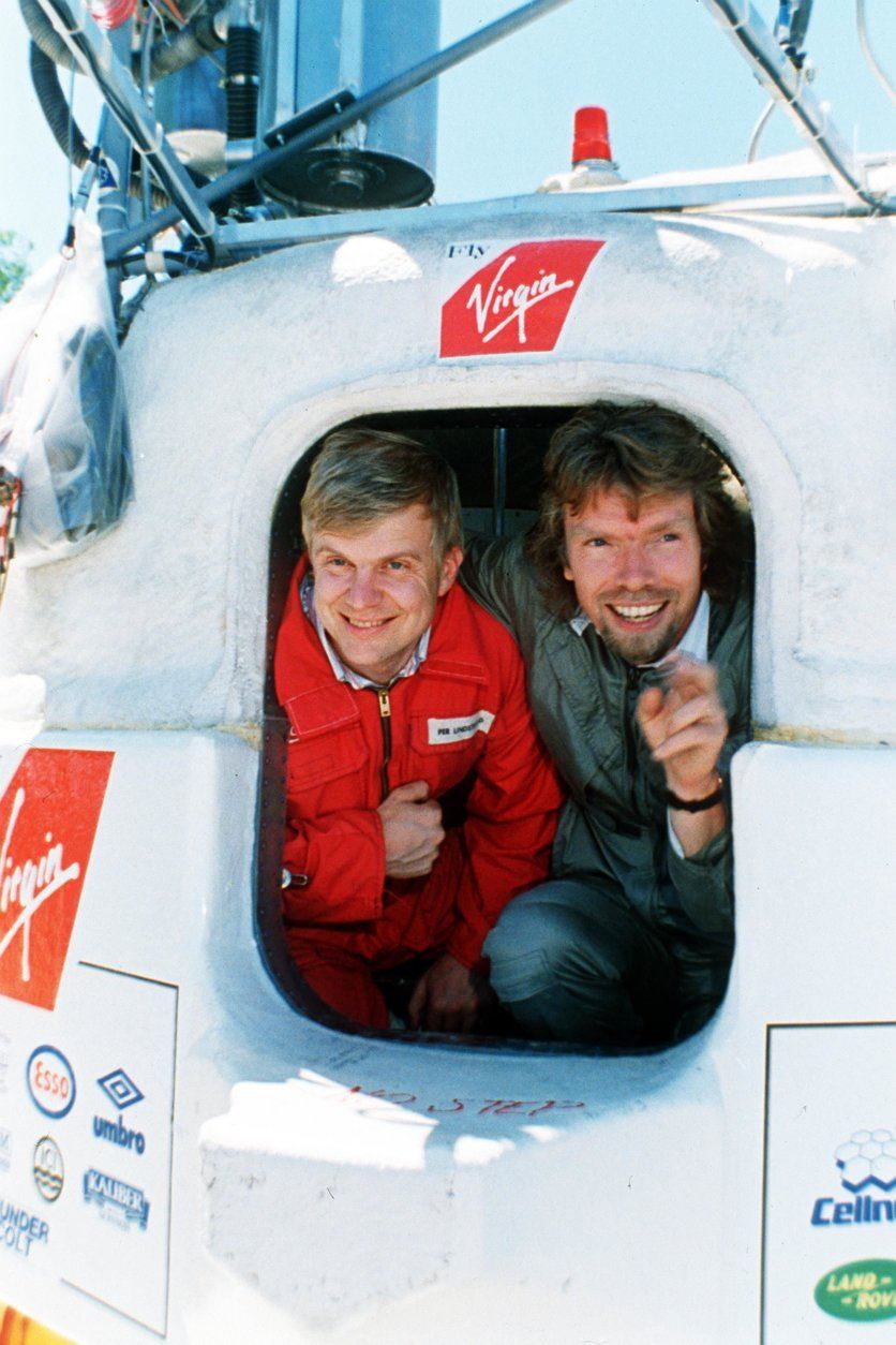 Richard Branson, right, and Per Lindstrand peer out of the capsule of their Virgin Atlantic Flyer hot air balloon at Carrabassett Valley, Maine, in June 1987. The pair hope the balloon will take them across the Atlantic to Great Britain. (AP Photo/Pat Wellenbach)