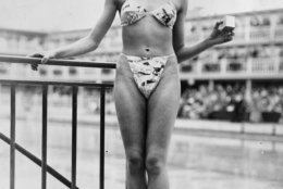 The new 'Bikini' swimming costume (in a newsprint-patterned fabric), which caused a sensation at a beauty contest at the Molitor swimming pool in Paris. Designer Louis Reard was unable to find a 'respectable' model for his costume and the job of displaying it went to 19-year-old Micheline Bernardini, a nude dancer from the Casino de Paris. She is holding a small box into which the entire costume can be packed. Celebrated as the first bikini, Luard's design came a few months after a similar two-piece design was produced by French designer Jacques Heim.   (Photo by Keystone/Getty Images)