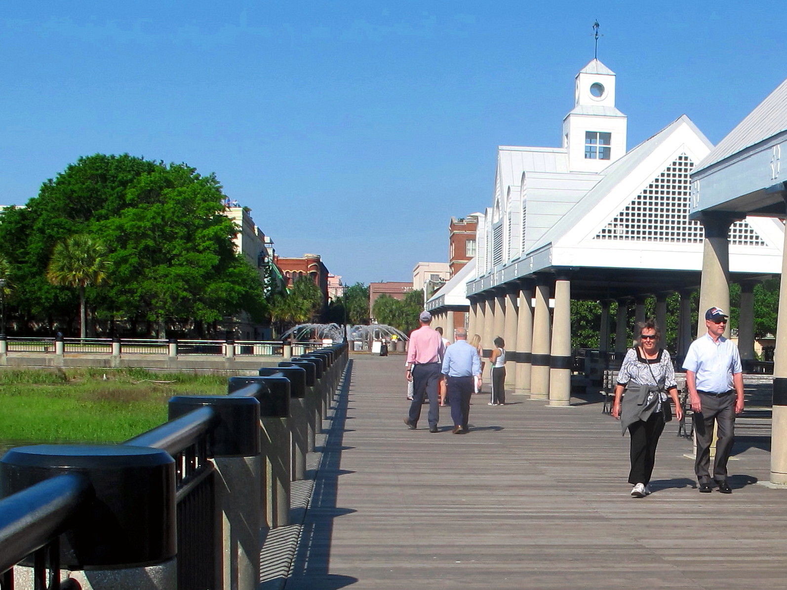 This April 23, 2015 photograph shows visitors walking along the pier at the Waterfront Park in Charleston, S.C. Figures released by the South Carolina Department of Parks, Recreation and Tourism show that, through the first half of 2015, its been another good year for South Carolina's $18 billion tourism industry. (AP Photo/Bruce Smith)