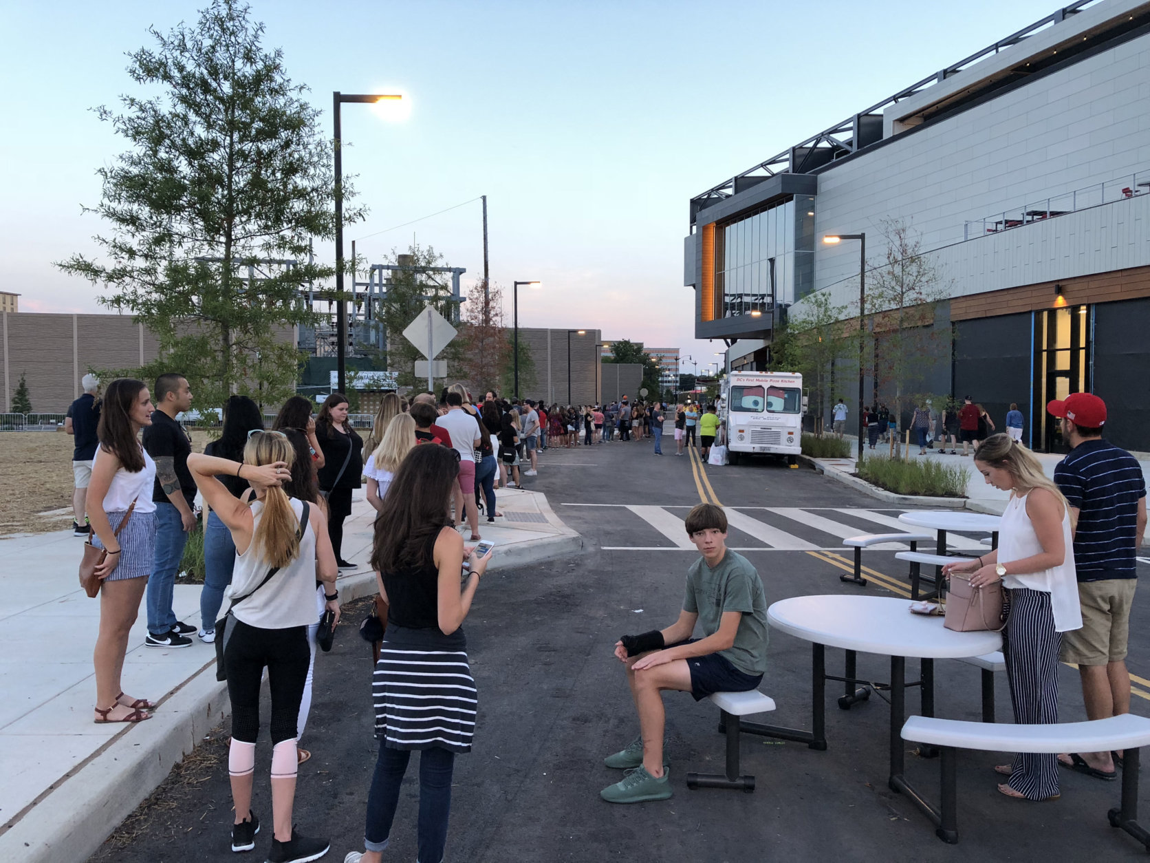 A line forms outside of Audi Field during a D.C. United Game on Saturday, July 28, 2018, for people to store their bags and purses. (WTOP/Mike McMearty)