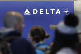 Travelers wait in line at the Delta Air Lines counter at Logan International Airport in Boston, Monday, Jan. 8, 2018. (AP Photo/Charles Krupa)