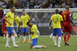 Brazil's Neymar, center, reacts after Brazil is knocked out by Belgium following their quarterfinal match at the 2018 soccer World Cup in the Kazan Arena, in Kazan, Russia, Friday, July 6, 2018. (AP Photo/Andre Penner)