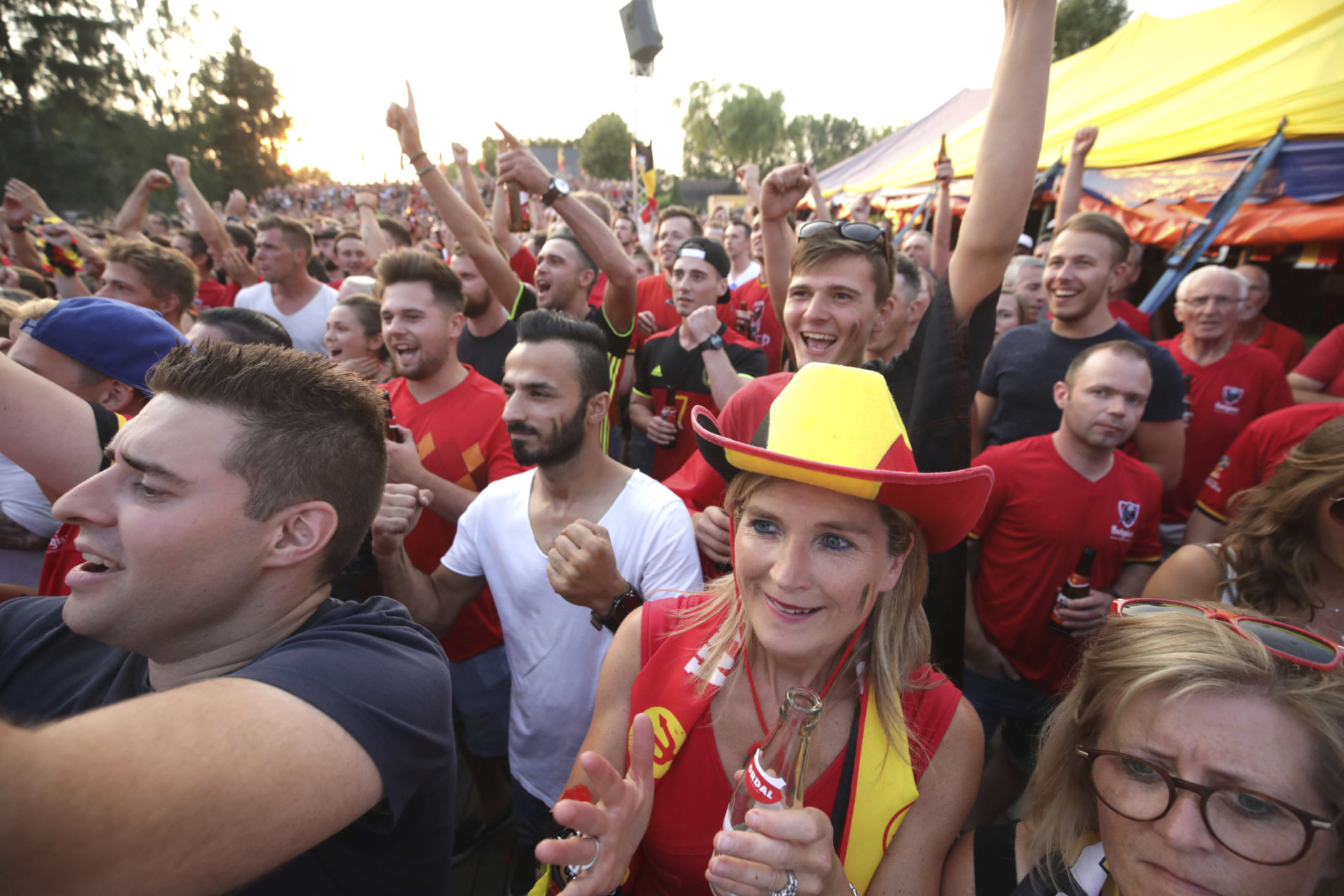 Belgian fans react as they watch a World Cup soccer match between Belgium and Brazil at a large screen event in Heist-op-den-Berg, Belgium, Friday, July 6, 2018. (AP Photo/Olivier Matthys)