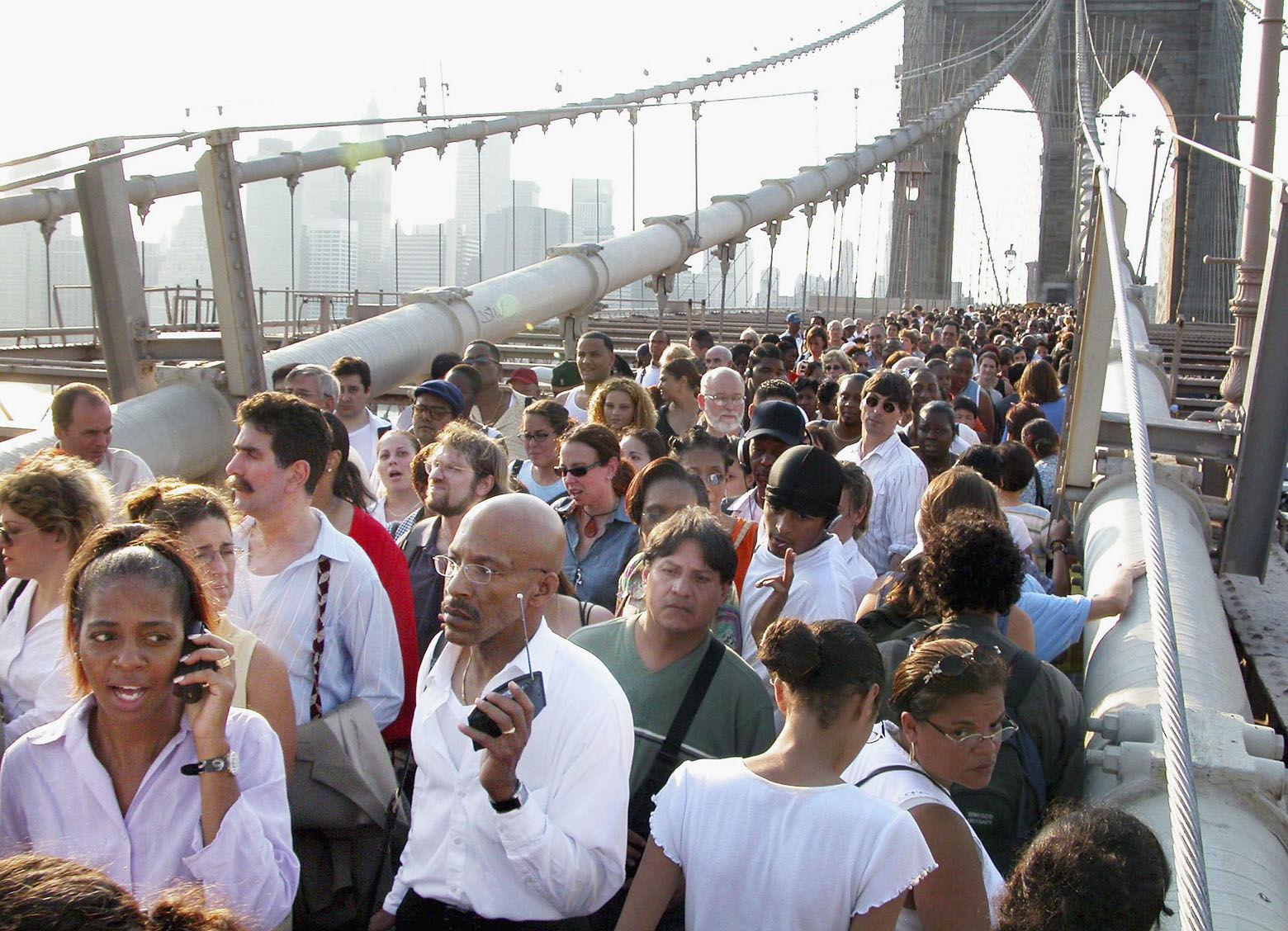 NEW YORK - AUGUST 14:  People walk down Brooklyn Bridge during a massive blackout August 14, 2003 in New York City. Officials from the Department of Homeland Security said there were no indications that terrorists were responsible for the blackout that has also affected Ohio, and Canada. (Photo by Jonathan Fickies/Getty Images)