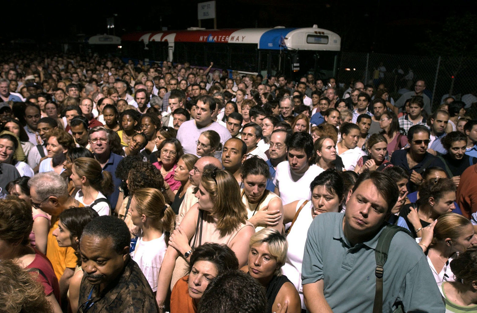 Thousands of commuters wait for a chance to board a ferry from Manhattan to the New Jersey side of the Hudson River, Thursday, Aug. 14, 2003, in New York, after a massive blackout shut down trains and subway lines.  (AP Photo/Julie Jacobson)