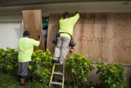 HONOLULU, HI - AUGUST 22:    Yamasaki Construction workers, Talbot Khakai, left, and David Halafihi board up McDonalds multiple plate glass windows in preparation for Hurricane Lane on Kalaukaua Ave on Wednesday, August 22, 2018 in Honolulu, Hawaii. Hurricane Lane is a high-end Category 4 hurricane and remains a threat to the entire island chain. (Photo by Kat Wade/Getty Images)
