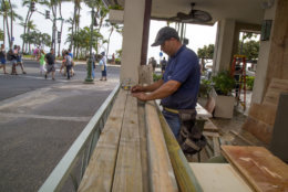 HONOLULU, HI - AUGUST 22:    Yamasaki Construction worker, foreman Nathan Koikoinui,  measures plywood to board up McDonalds multiple plate glass windows in preparation for Hurricane Lane on Kalaukaua Ave on Wednesday, August 22, 2018 in Honolulu, Hawaii. Hurricane Lane is a high-end Category 4 hurricane and remains a threat to the entire island chain. (Photo by Kat Wade/Getty Images)