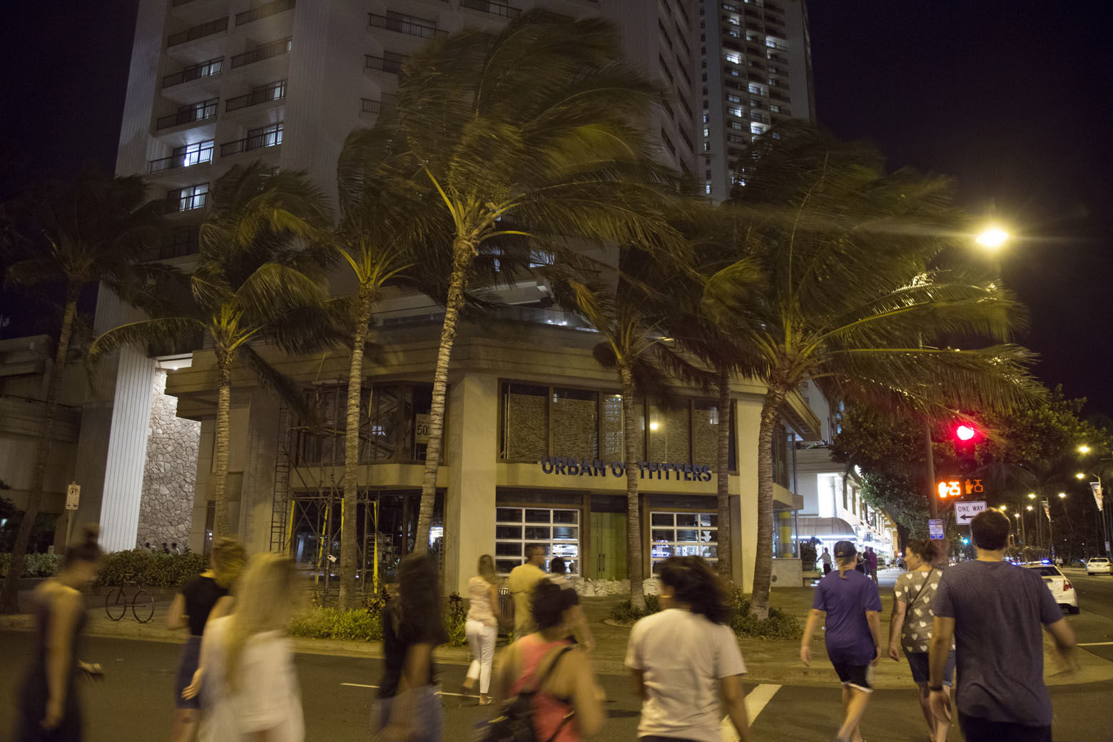 HONOLULU, HI - AUGUST 23: 2018   Fewer than the normal amount of nightly tourists stroll the streets of Waikiki as Hurricane Lane approaches Waikiki Beach on Thursday, August 23, 2018 in Honolulu, Hi.   (Photo by Kat Wade/Getty Images)