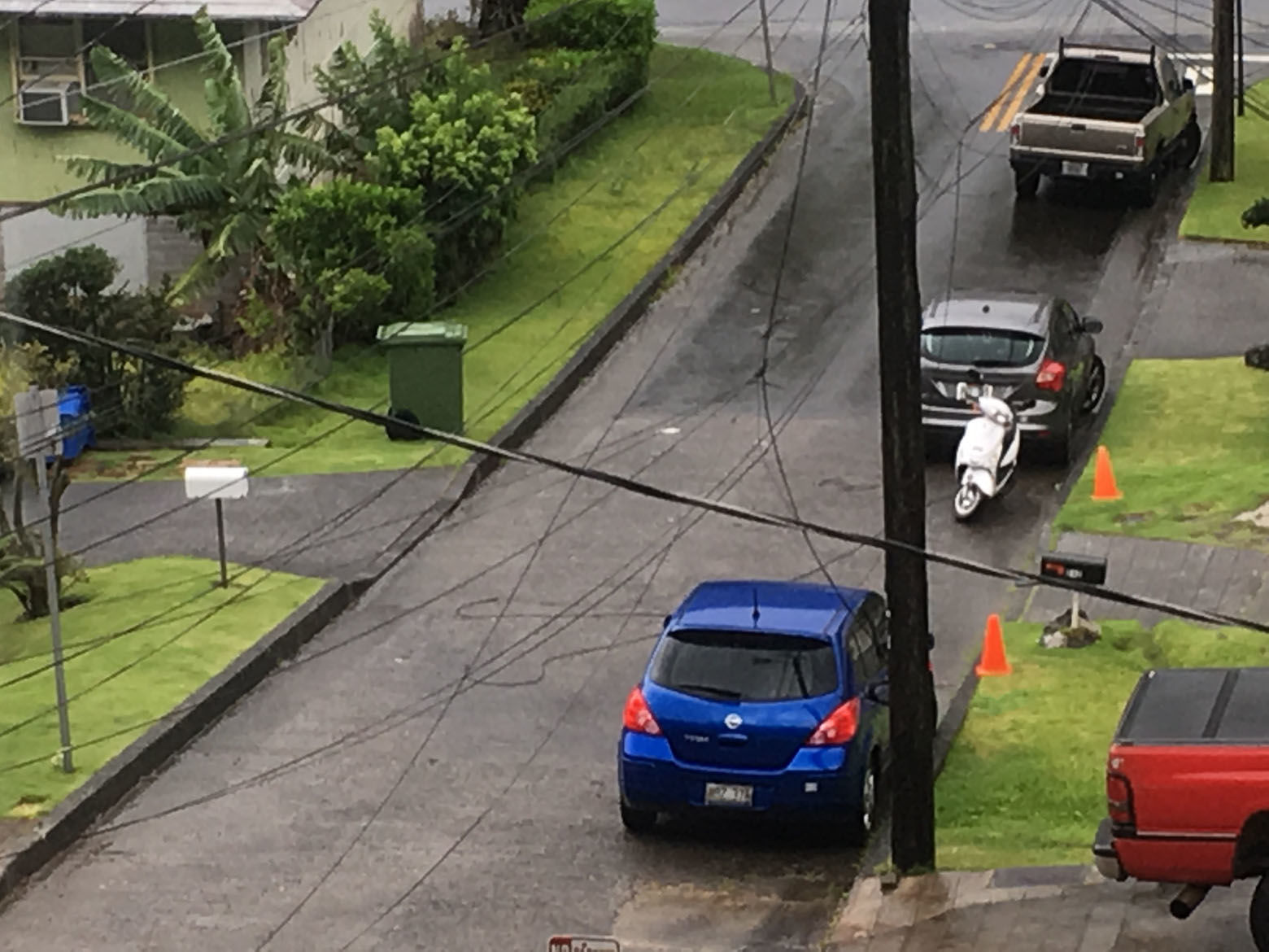 A utility line lays in the street in the Nuuanu neighborhood of Honolulu, Friday, Aug. 24, 2018, as Hurricane Lane approaches. Hurricane Lane barreled toward Hawaii on Friday, dumping torrential rains that caused flooding on the Big Island as people stocked up on supplies and piled sandbags to shield oceanfront businesses against the increasingly violent surf. (AP Photo/Caleb Jones)
