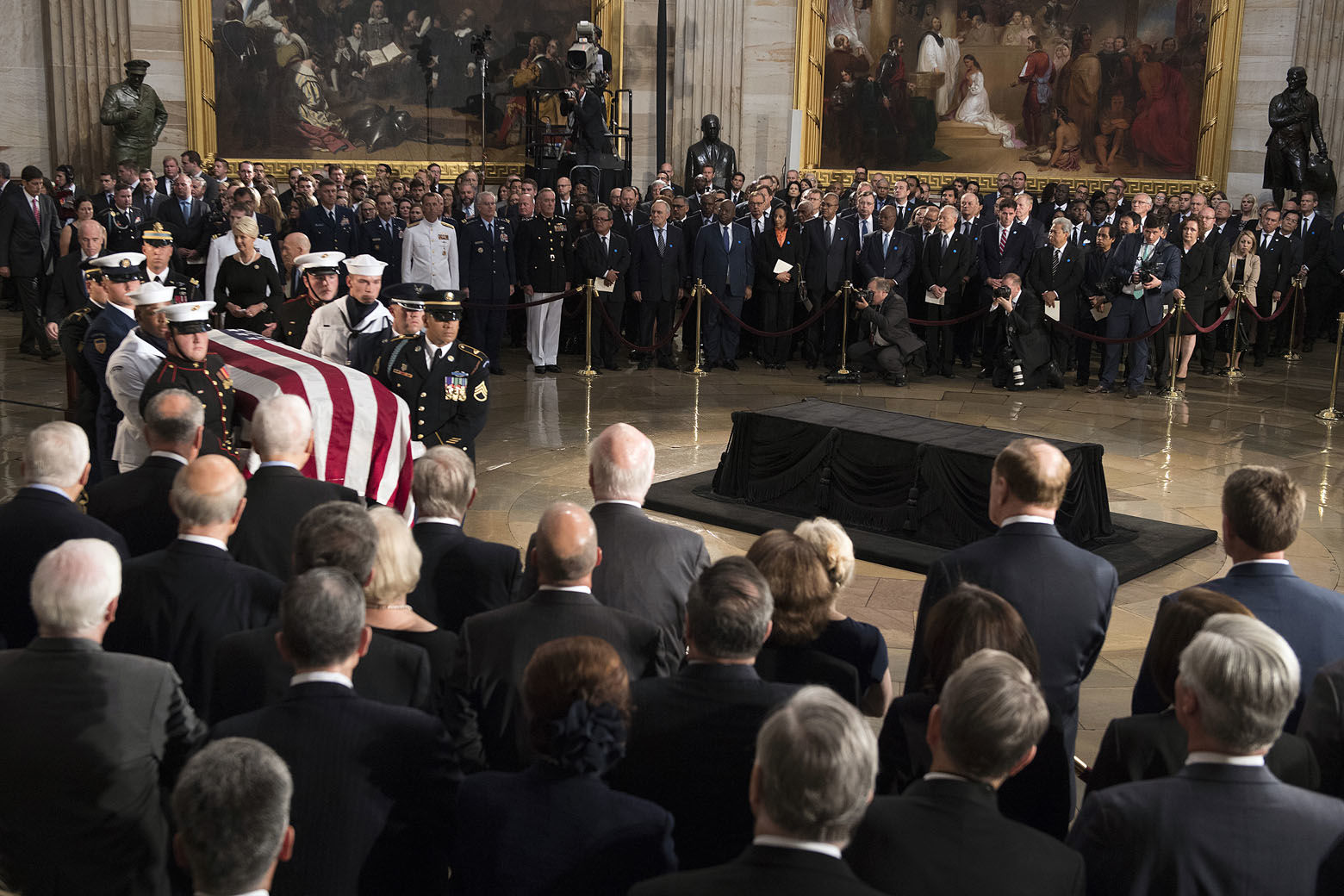 The flag-draped casket of Sen. John McCain, R-Ariz., is carried into the U.S. Capitol Rotunda Friday, Aug. 31, 2018, in Washington, to be placed on the Lincoln Catafalque. (Jim Watson/Pool Photo via AP)