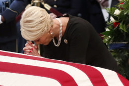 Cindy McCain pauses at the casket of her husband Sen. John McCain, R-Ariz., during a ceremony as McCain lies in state at the Rotunda of the U.S. Capitol in Washington, Friday, Aug. 31, 2018. (Kevin Lamarque/Pool Photo via AP)