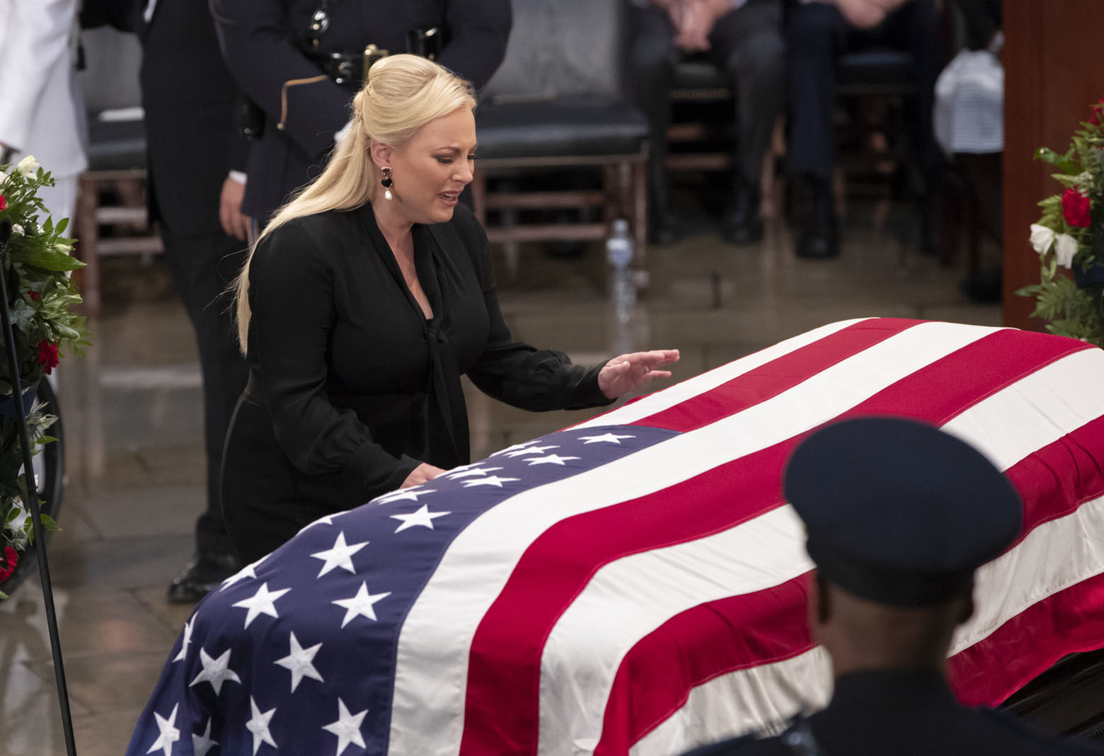 Meghan McCain reaches out to touch the flag-draped casket bearing the remains of her father, Sen. John McCain, R-Ariz., during a farewell ceremony in the Capitol Rotunda, Friday, Aug. 31, 2018, in Washington.  (AP Photo/J. Scott Applewhite)