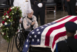 Roberta McCain, the 106-year-old mother of Sen. John McCain of Arizona, stops at his flag-draped casket in the U.S. Capitol rotunda during a farewell ceremony, Friday, Aug. 31, 2018, in Washington. (AP Photo/J. Scott Applewhite)