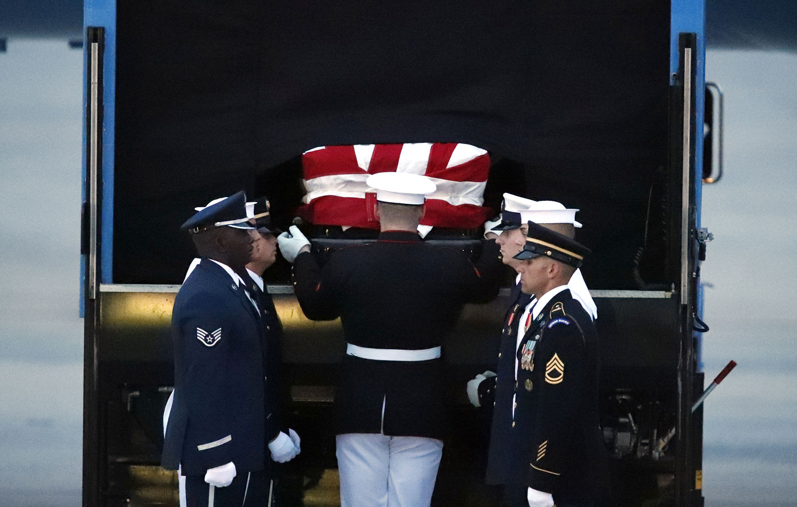The flag-draped casket of Sen. John McCain, R-Ariz., is removed to be carried by an Armed Forces body bearer team to a hearse, Thursday, Aug. 30, 2018, at Andrews Air Force Base, Md. (AP Photo/Alex Brandon)