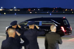 Defense Secretary Jim Mattis, right, and others stand as the flag-draped casket of Sen. John McCain, R-Ariz., departs in a hearse, Thursday, Aug. 30, 2018, at Andrews Air Force Base, Md. (AP Photo/Alex Brandon)