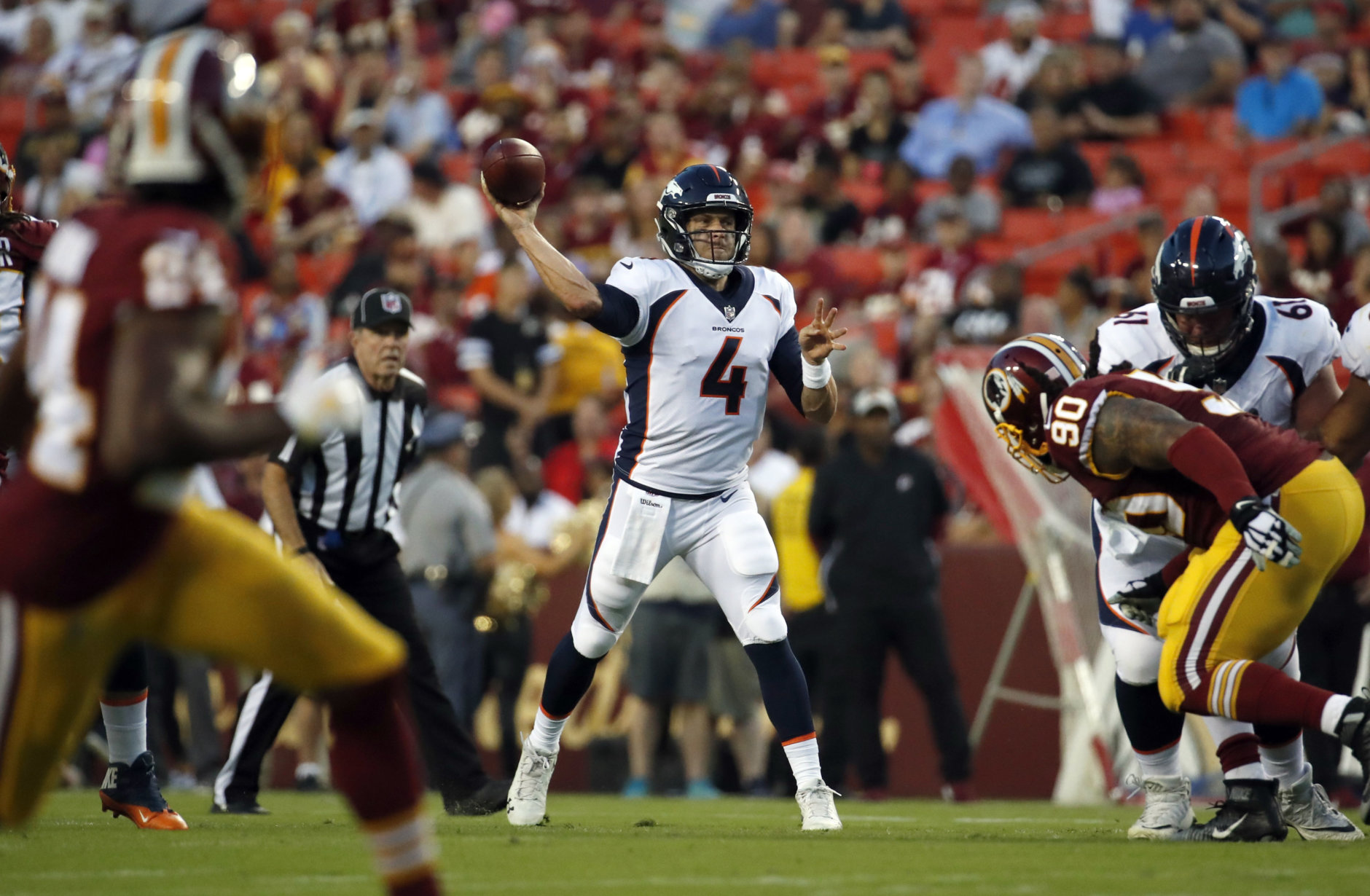 Denver Broncos quarterback Case Keenum (4) throws a pass during the first half of the team's preseason NFL football game against the Washington Redskins on Friday, Aug. 24, 2018, in Landover, Md. (AP Photo/Alex Brandon)