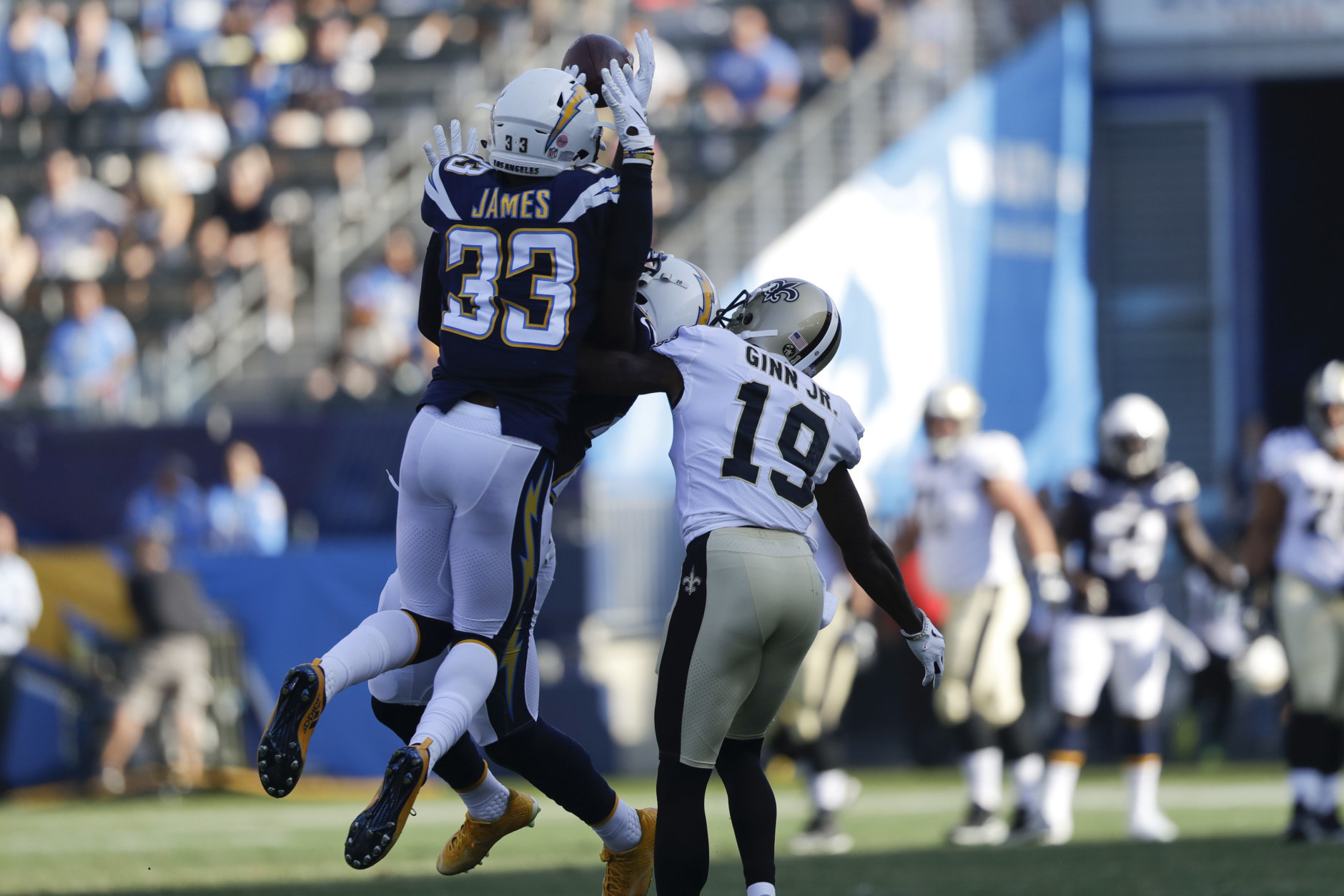 Los Angeles Chargers defensive back Derwin James (33) intercepts a pass over New Orleans Saints wide receiver Ted Ginn (19) during the first half of an NFL preseason football game Saturday, Aug. 25, 2018, in Carson, Calif. (AP Photo/Marcio Jose Sanchez)