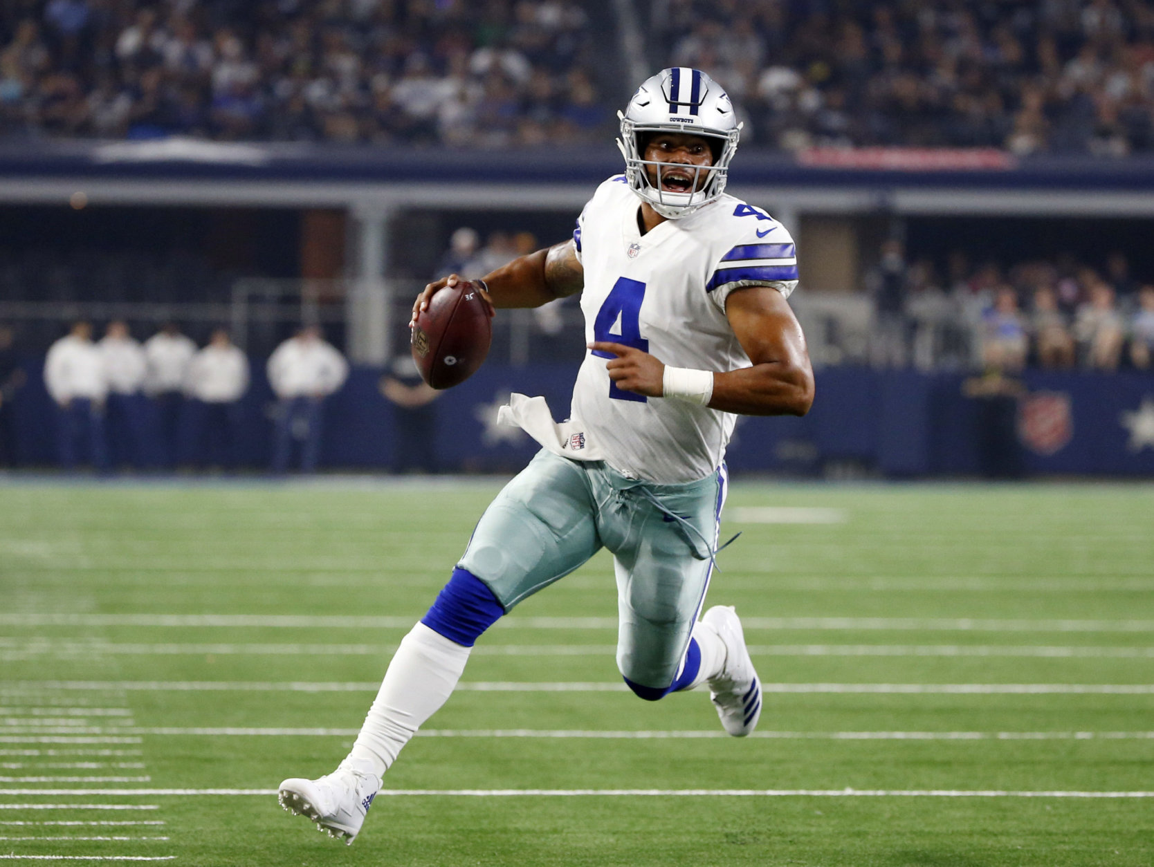 FILE - In this Aug. 18, 2018, file photo, Dallas Cowboys quarterback Dak Prescott (4) scrambles during the first half of a preseason NFL football game against the Cincinnati Bengals, in Arlington, Texas. Prescott dealt with the uncertainty of running back Ezekiel Elliott’s looming six-game suspension last year when the Dallas Cowboys slid from an NFC-best 13 wins to out of the playoffs. Now the star quarterback faces the unknown of a revamped and largely unproven group of receivers after the departures of Jason Witten and Dez Bryant. Elliott, Prescott’s fellow rookie standout from two years ago, is the supposed sure thing for a team looking up in the NFC East at defending Super Bowl champ Philadelphia.(AP Photo/Ron Jenkins, File)