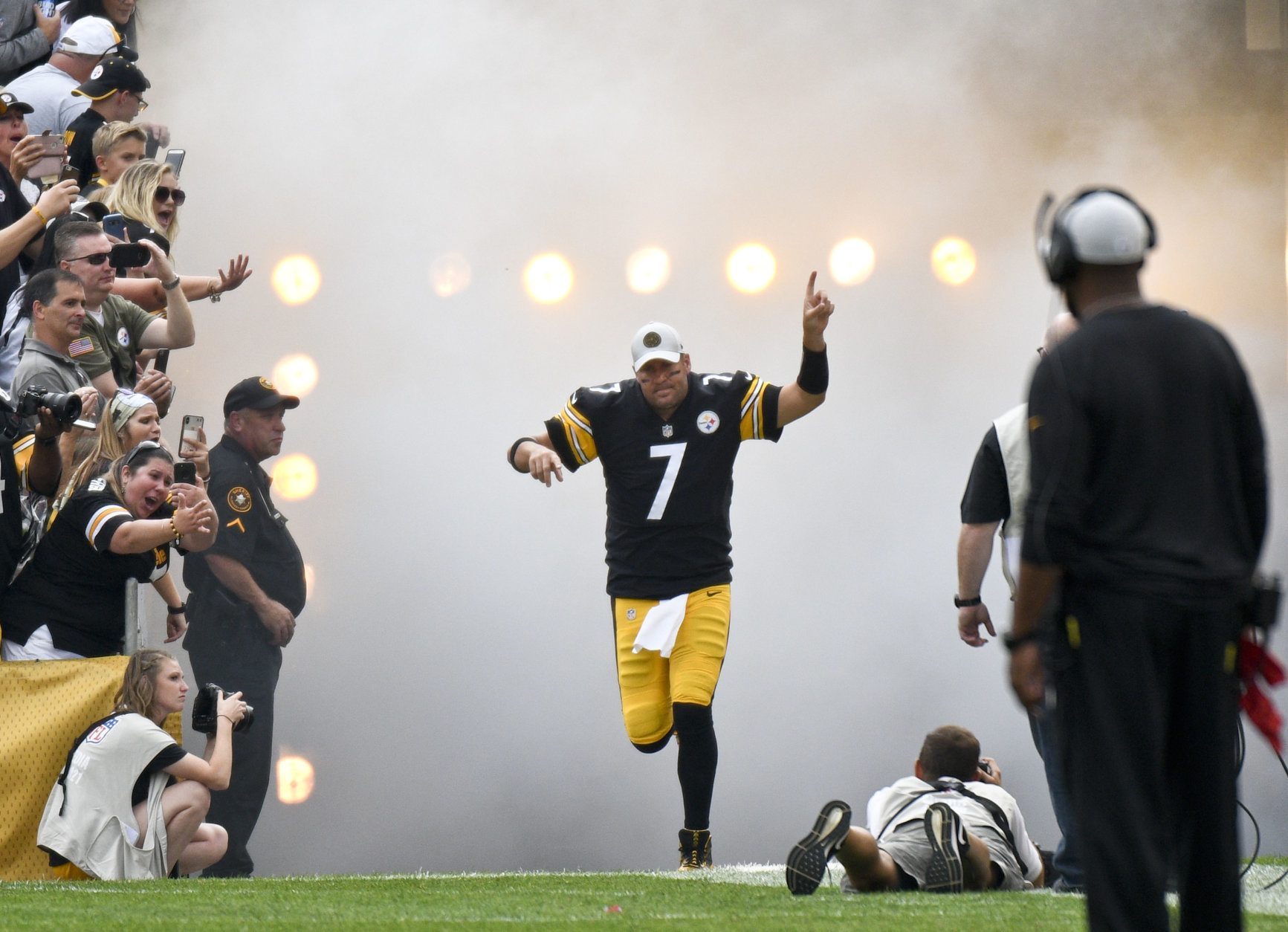 In this photo from Aug. 25, 2018, Pittsburgh Steelers quarterback Ben Roethlisberger (7) takes the field as fans and head coach Mike Tomlin, right, watch before an NFL preseason football game against the Tennessee Titans in Pittsburgh. Roethlisberger feels rejuvenated entering his 15th season. Yet even as he considers extending his career beyond 2019, he is well aware that time is of the essence for the two-time defending AFC North champions.(AP Photo/Don Wright)
