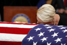 Cindy McCain, wife of, Sen. John McCain, R-Ariz. lays her head on the casket during a memorial service at the Arizona Capitol on Wednesday, Aug. 29, 2018, in Phoenix. (AP Photo/Jae C. Hong, Pool)