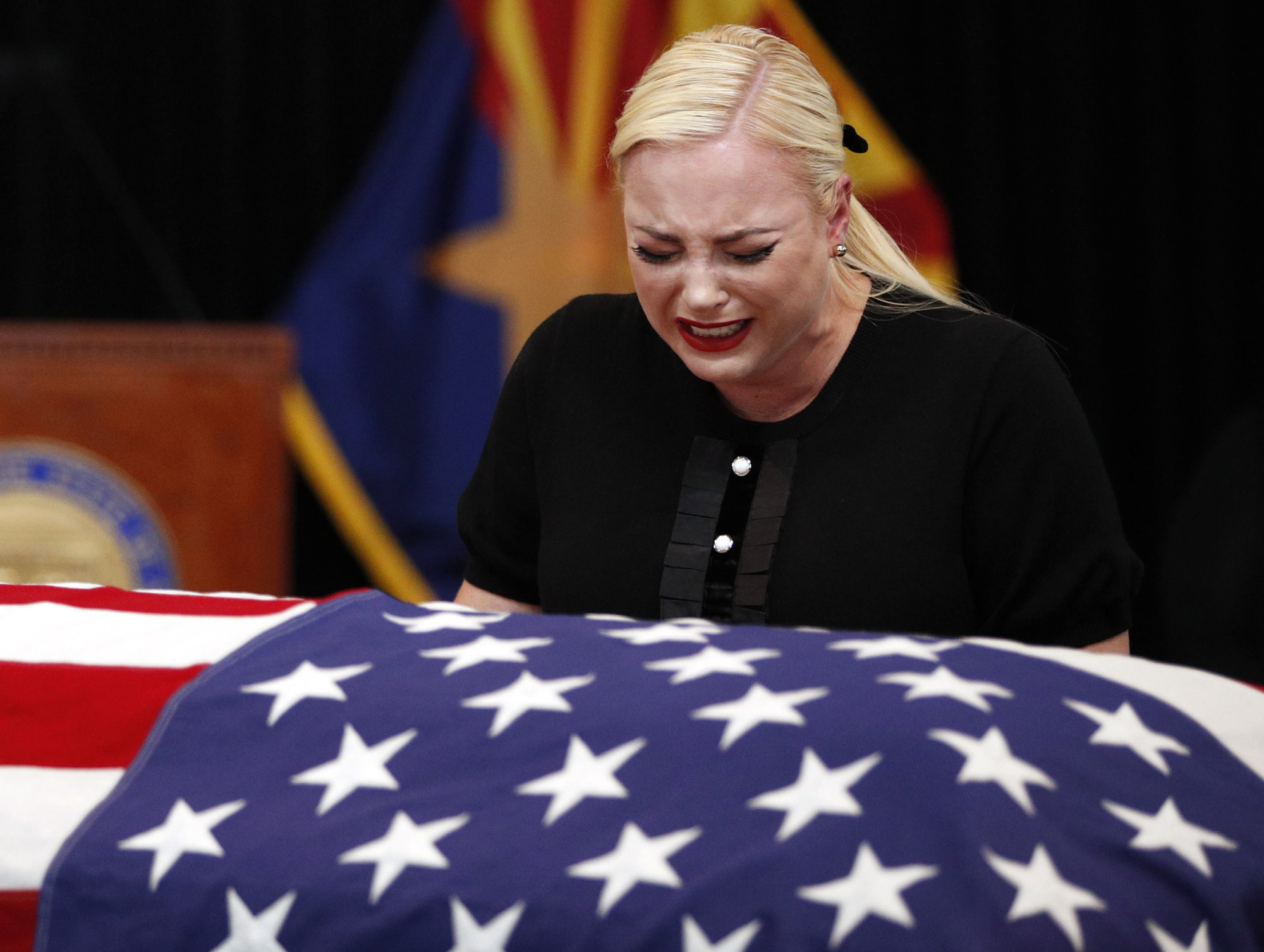 Meghan McCain, daughter of, Sen. John McCain, R-Ariz. cries at the casket of her father during a memorial service at the Arizona Capitol on Wednesday, Aug. 29, 2018, in Phoenix. (AP Photo/Jae C. Hong, Pool)