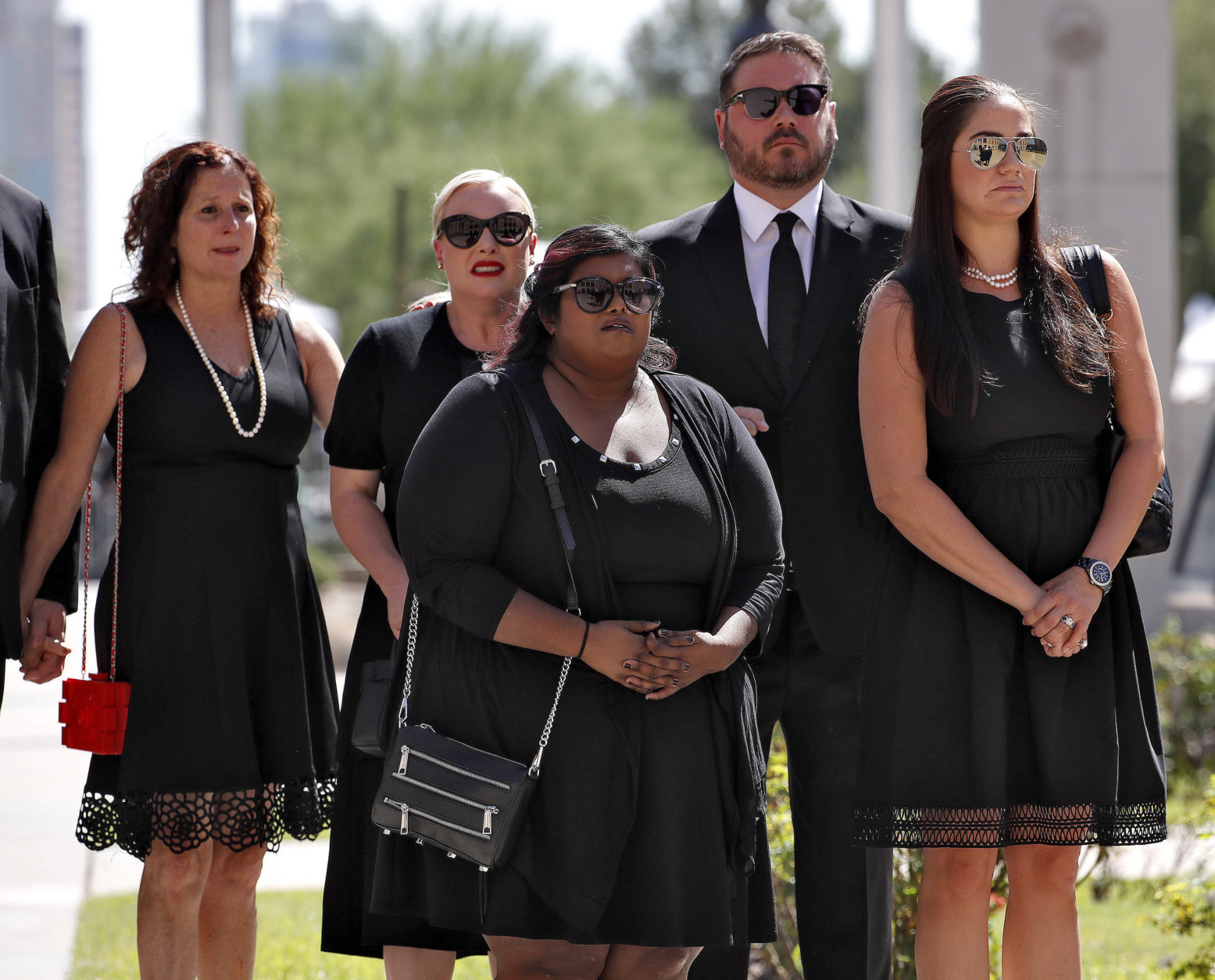 Children of Sen. John McCain, R-Ariz., from back left Sidney McCain, Meghan McCain and her husband Ben Domenech, Bridget McCain, front center and daughter-in-law Holly McCain, follow behind the casket into the Capitol rotunda for a memorial service, Wednesday, Aug. 29, 2018, at the Capitol in Phoenix. (AP Photo/Matt York)