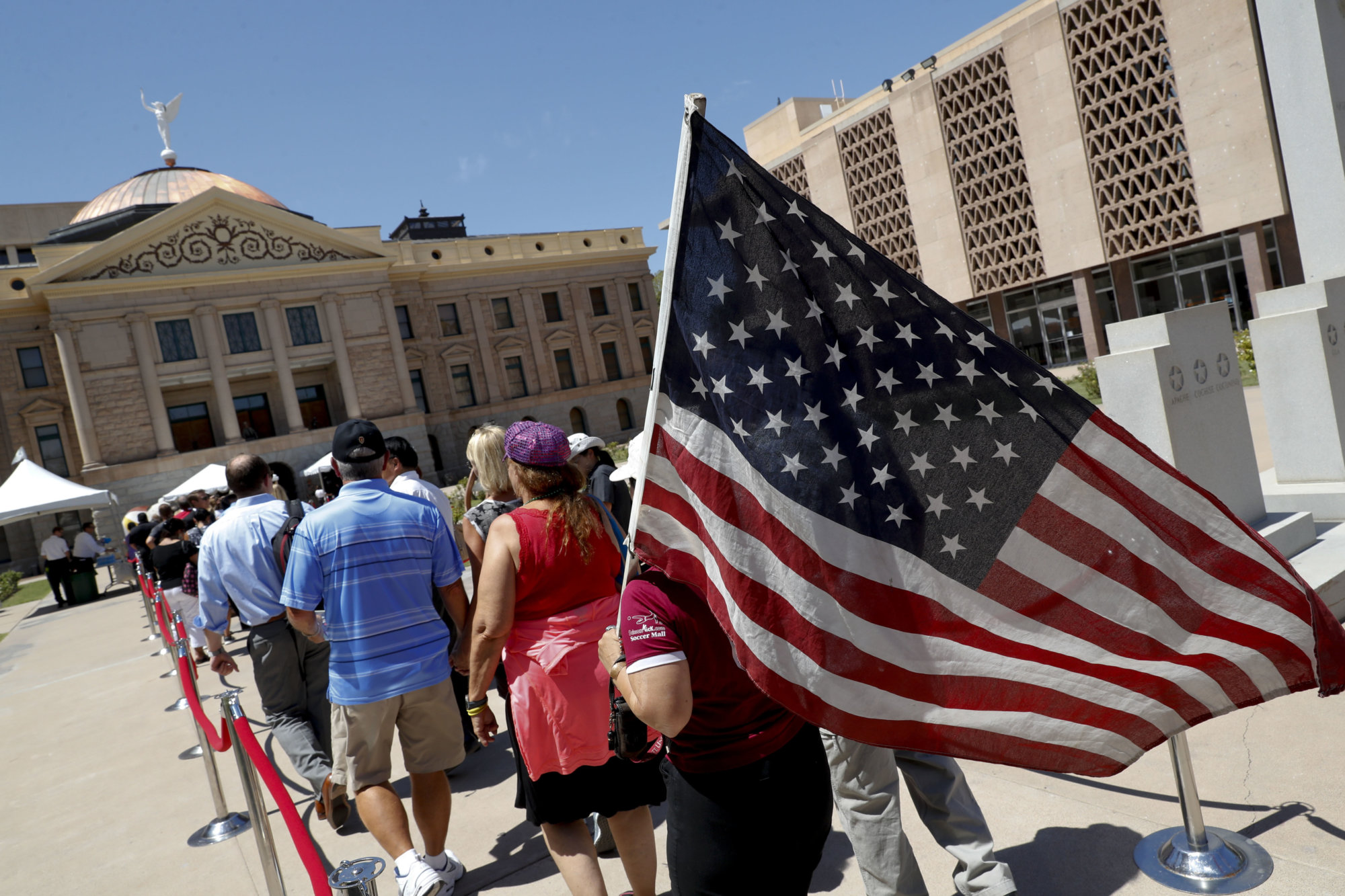 Members of the public line up to pay their respects to Sen. John McCain during a viewing at the Arizona Capitol on Wednesday, Aug. 29, 2018, in Phoenix. (AP Photo/Matt York)