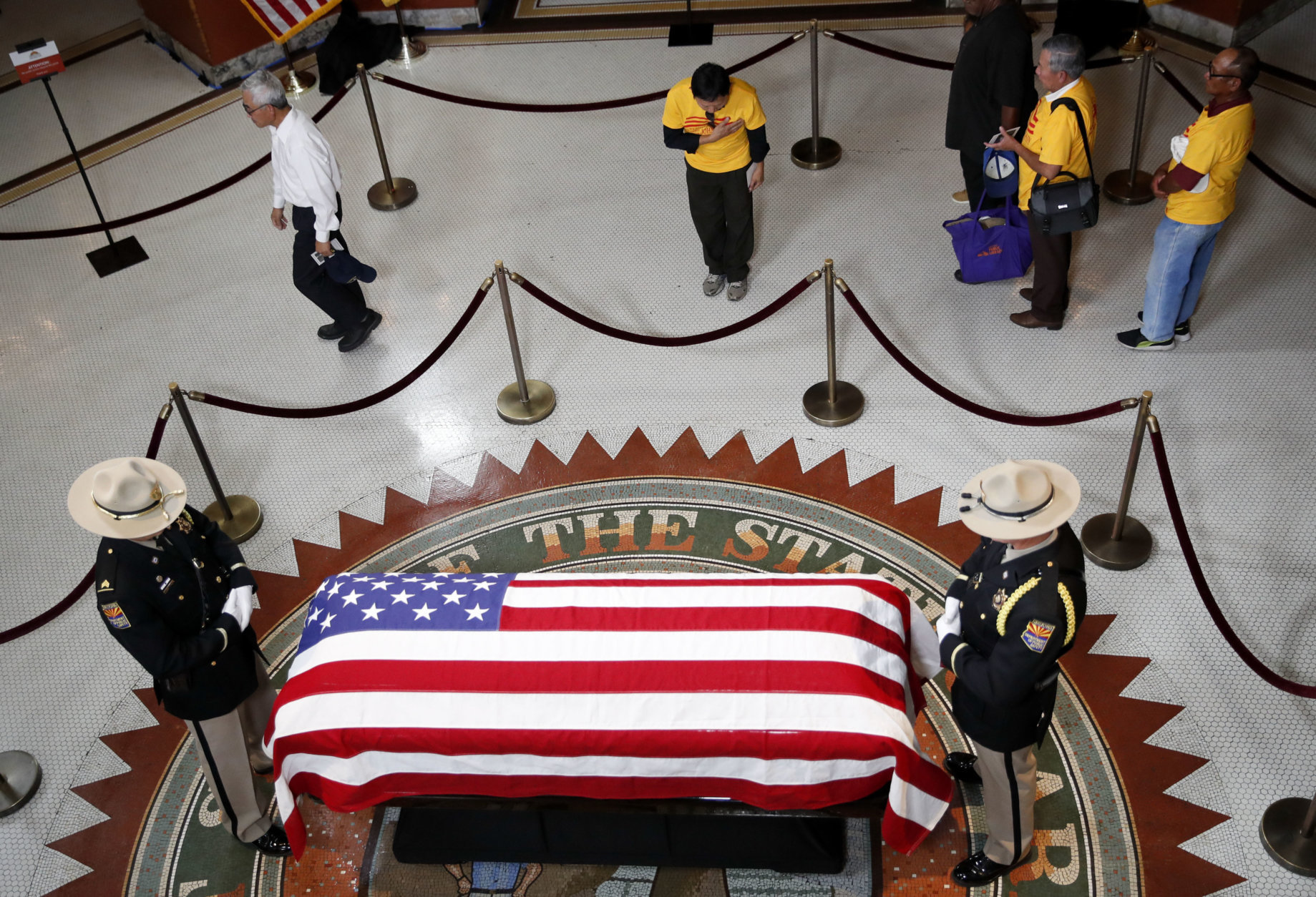 A Vietnamese group from Orange County, Calif., pays their respects near the casket of Sen. John McCain during a viewing at the Arizona Capitol on Wednesday, Aug. 29, 2018, in Phoenix. (AP Photo/Jae C. Hong)