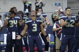 Seattle Seahawks quarterback Russell Wilson (3) gestures as he looks up after the singing of the national anthem before the team's NFL football preseason game against the Oakland Raiders, Thursday, Aug. 30, 2018, in Seattle. (AP Photo/Elaine Thompson)
