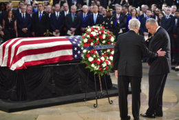 Senate Minority Leader Chuck Schumer, D-N.Y., left, and Senate Majority Leader Mitch McConnell, R-Ky., place a wreath near at the flag-draped casket bearing the remains of Sen. John McCain of Arizona, who lived and worked in Congress over four decades, during a ceremony in the U.S. Capitol rotunda, Friday, Aug. 31, 2018, in Washington. (Kevin Dietsch/Pool Photo via AP)
