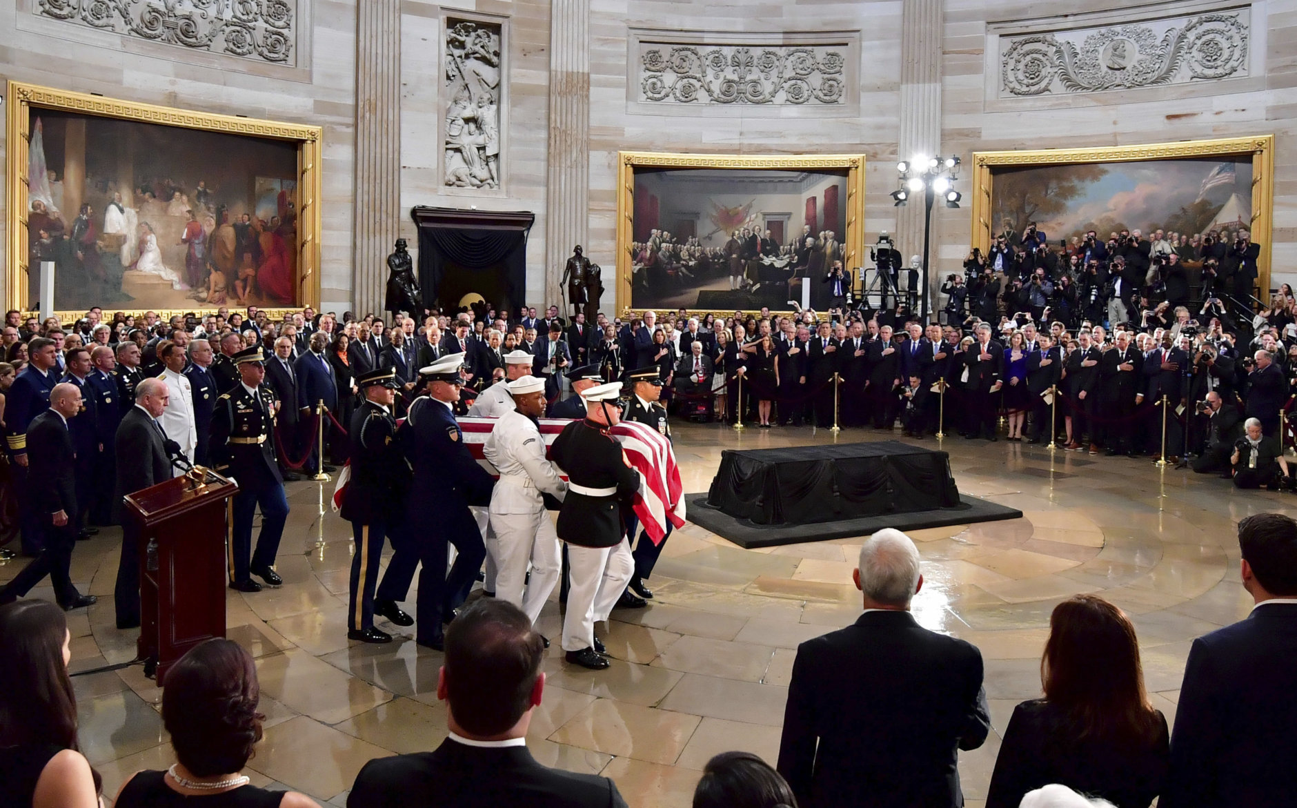 The flag-draped casket of Sen. John McCain, R-Ariz., is carried into the U.S. Capitol Rotunda Friday, Aug. 31, 2018, in Washington, to be placed on the Lincoln Catafalque. Kevin Dietsch/Pool Photo via AP)