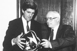 Sen. John Kerry (D-Mass.), chairman of the Senate Select Committee on POW-MIA Affairs, left, gives Sen. John McCain (R-Ariz.), a member of the committee, his pilot's helmet on Capitol Hill in Washington, Dec. 2, 1992. Kerry gave the helmet to McCain after retrieving it from the Vietnamese on a recent trip to Hanoi to investigate the POW/MIA issue. McCain was held prisoner in Vietnam during the war. (AP Photo/U.S. Senate)