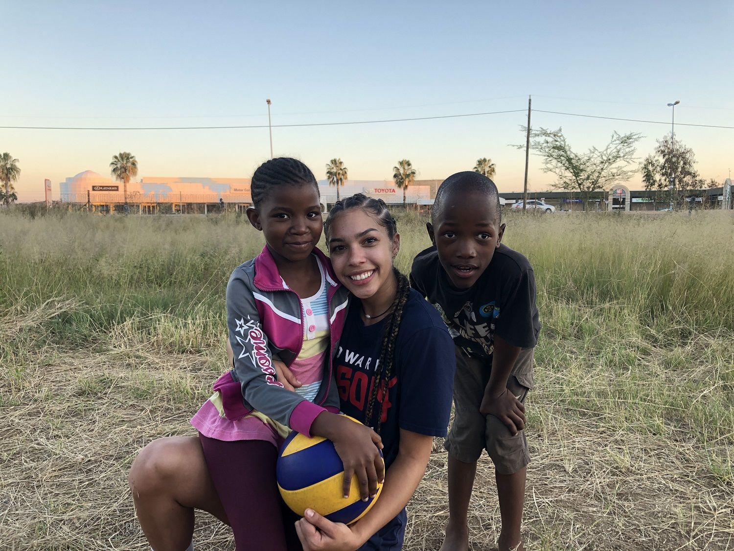 Sophomore libero Abby Morrow poses with some local children on the trip. The team held youth clinics in addition to playing national and local university teams. (Courtesy Howard Athletics)