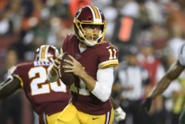 Washington Redskins quarterback Alex Smith (11) looks to pass during the first half of a preseason NFL football game against the New York Jets, Thursday, Aug. 16, 2018, in Landover, Md. (AP Photo/Nick Wass)