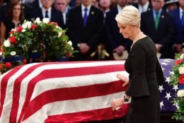 Cindy McCain touches the casket of her husband, former Sen. John McCain, R-Ariz., in the Capitol Rotunda where he will lie in state at the U.S. Capitol, in Washington, Friday, Aug. 31, 2018. (Kevin Dietsch/Pool Photo via AP)