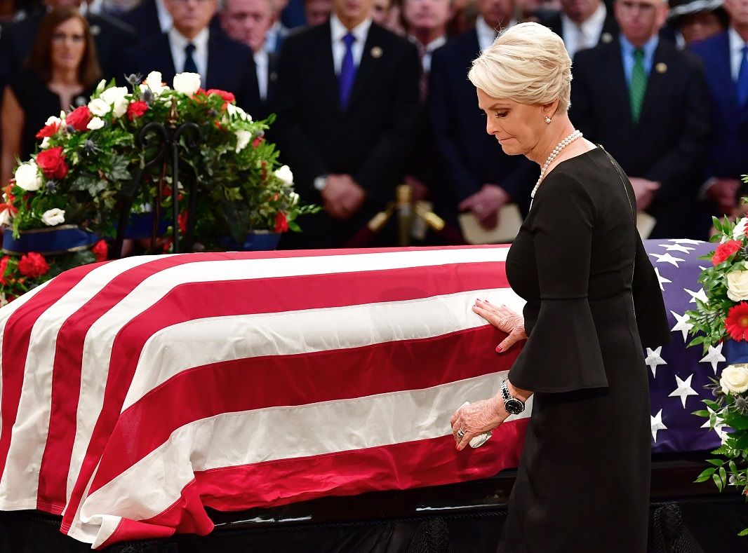 Cindy McCain touches the casket of her husband, former Sen. John McCain, R-Ariz., in the Capitol Rotunda where he will lie in state at the U.S. Capitol, in Washington, Friday, Aug. 31, 2018. (Kevin Dietsch/Pool Photo via AP)