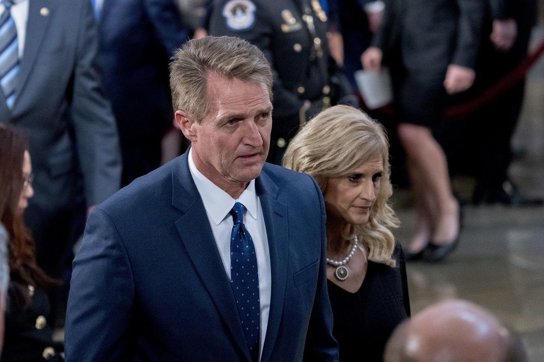 Sen. Jeff Flake, R-Ariz., and his wife Cheryl Flake depart a ceremony for Sen. John McCain, R-Ariz., as he lies in state in the Rotunda of the U.S. Capitol, Friday, Aug. 31, 2018, in Washington. (AP Photo/Andrew Harnik, Pool)