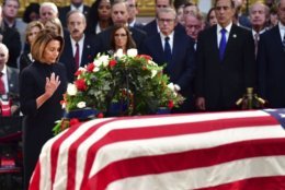 House Minority Leader Nancy Pelosi pause by the casket of Sen. John McCain, R-Ariz., in the Capitol Rotunda where he will lie in state at the U.S. Capitol, in Washington, Friday, Aug. 31, 2018. (Kevin Dietsch/Pool Photo via AP)