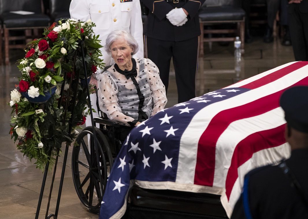 Roberta McCain, the 106-year-old mother of Sen. John McCain, R-Ariz., stops at his flag-draped casket in the U.S. Capitol rotunda during a farewell ceremony, Friday, Aug. 31, 2018, in Washington. McCain was a six-term senator, a former Republican nominee for president, and a Navy pilot who served in Vietnam, where he endured five-and-a-half years as a prisoner of war. He died Aug. 25 from brain cancer at age 81. (AP Photo/J. Scott Applewhite)