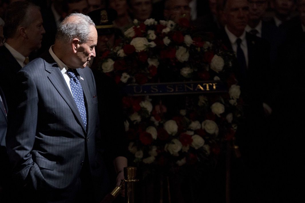 Senate Minority Leader Sen. Chuck Schumer of N.Y. watches as a wreath is brought in to be placed at the casket of Sen. John McCain, R-Ariz., as he lies in state in the Rotunda of the U.S. Capitol, Friday, Aug. 31, 2018, in Washington. (AP Photo/Andrew Harnik, Pool)