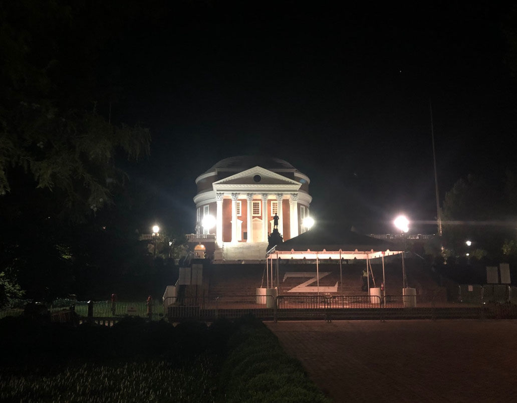A guard stands at the rotunda in the University of Virginia in Charlottesville on Friday, Aug. 10, 2018. The area has been fenced off in the wake of the first year since white nationalists circled protesters on campus. (WTOP/Max Smith)