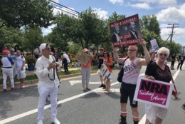 Hundreds rallies in the street outside the NRA headquarters on Saturday afternoon. (WTOP/Melissa Howell)